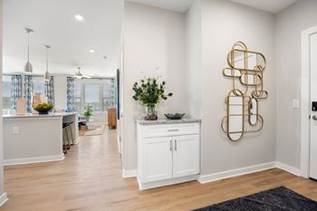 a kitchen and living room with white cabinets and a counter